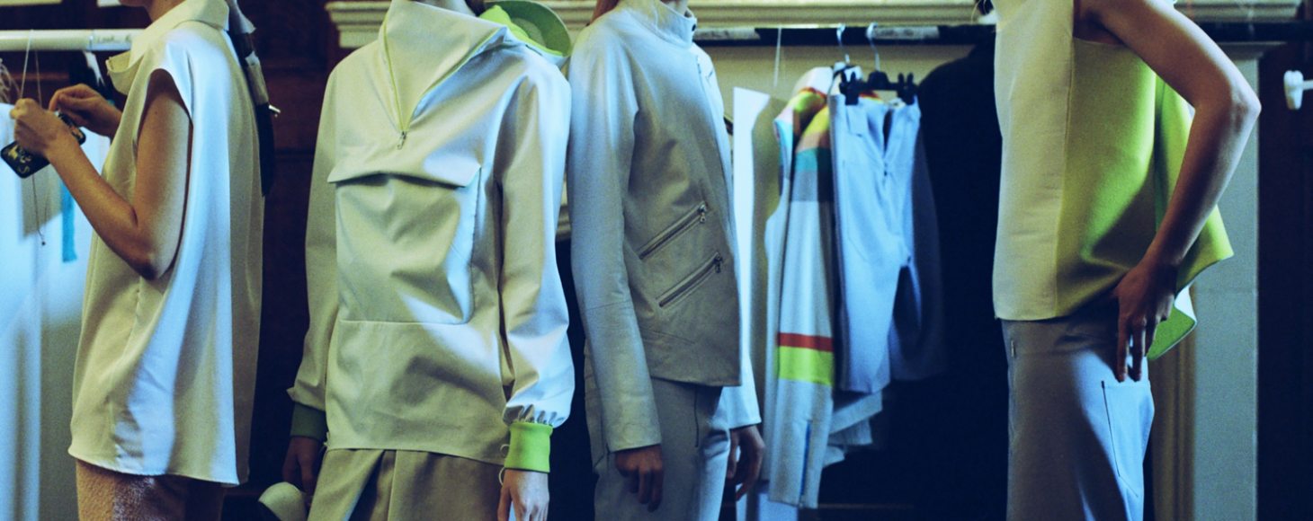 Behind the scenes of a fashion show where models are getting ready