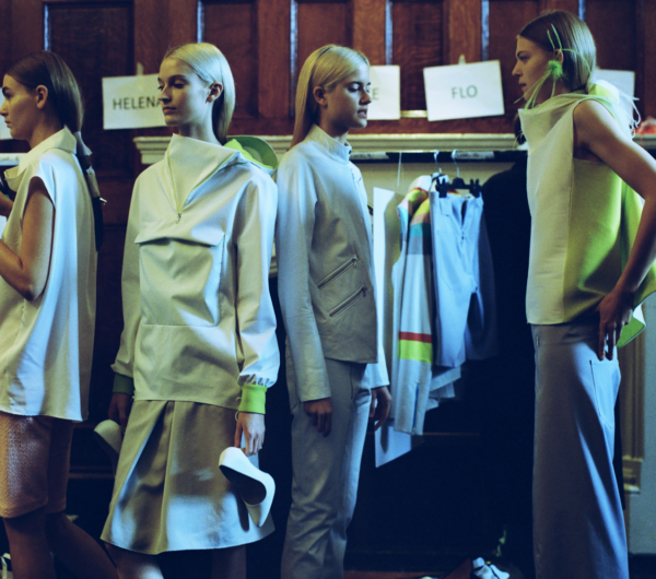 Behind the scenes of a fashion show where models are getting ready