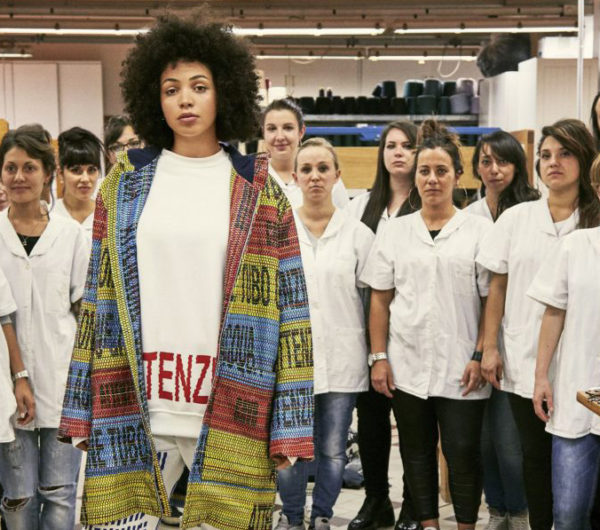 A jacket is shown designed by Bethany Williams in a studio
