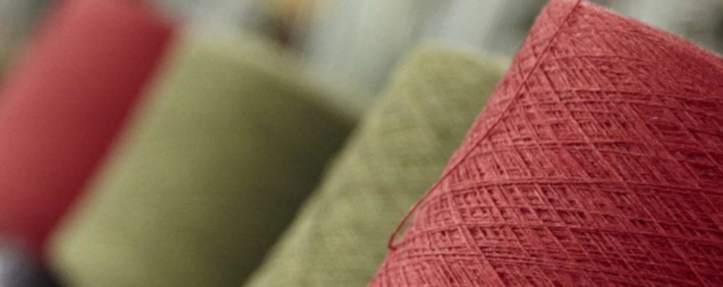 Green and red yarn spools in a mill