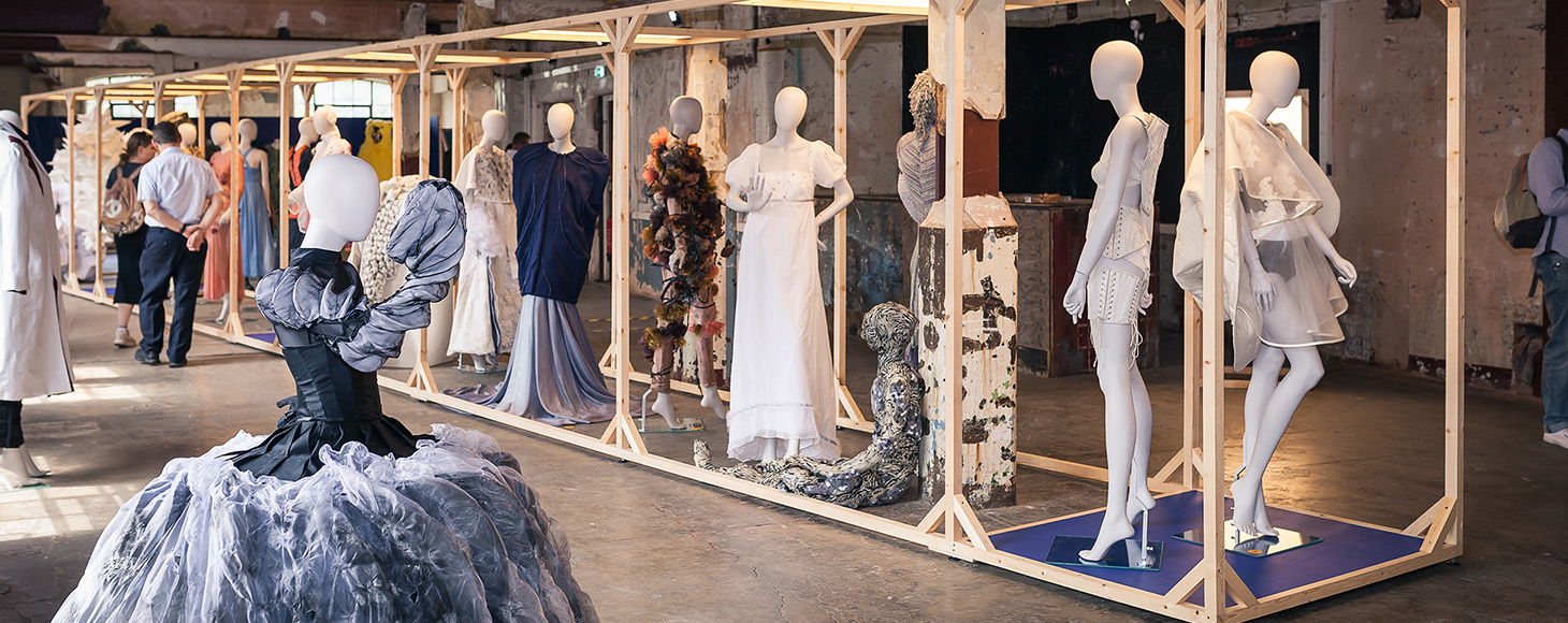 A collection of garments shown in an exhibition space