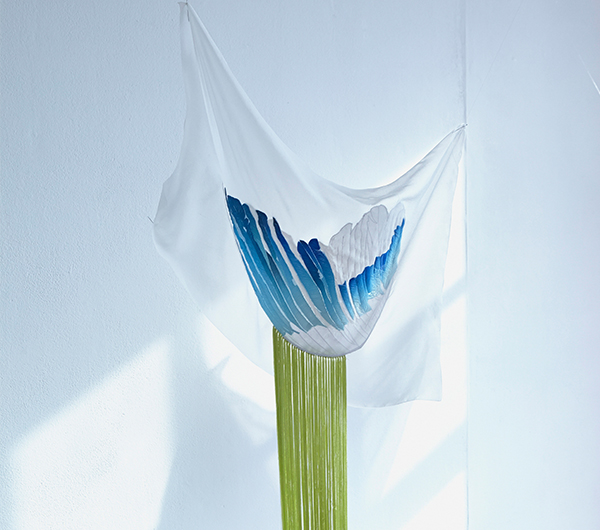 A white fabric is shown in close up detail with