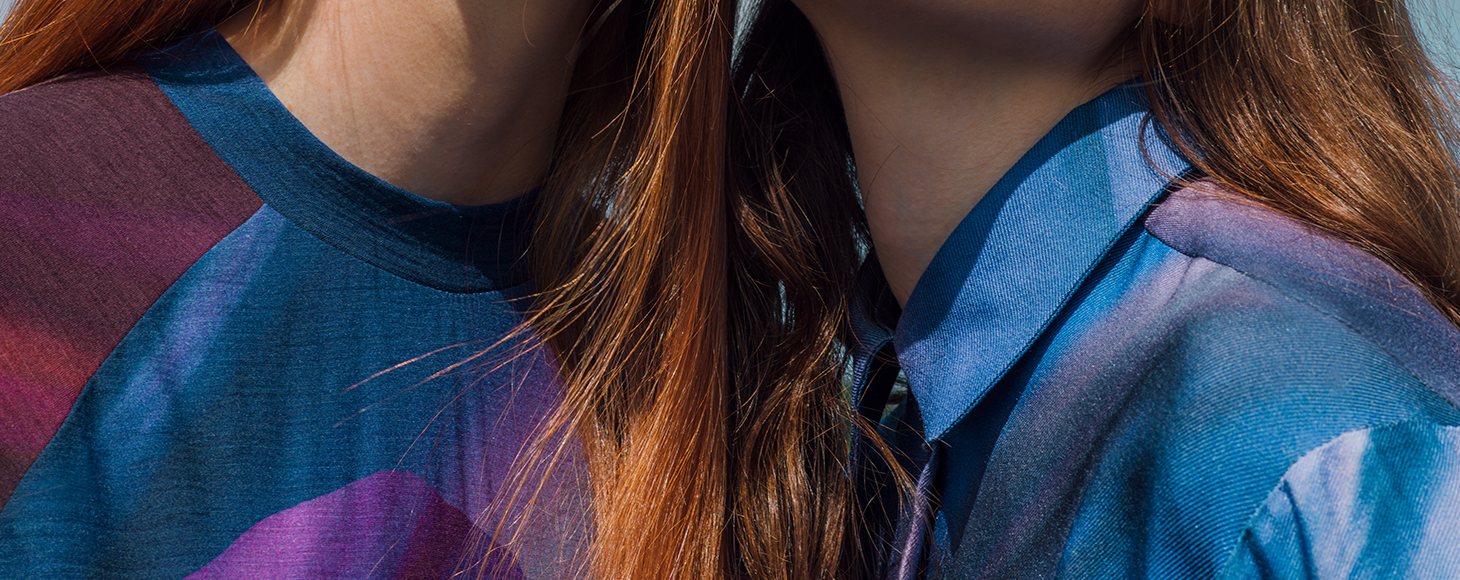 Two female models wearing blue garments