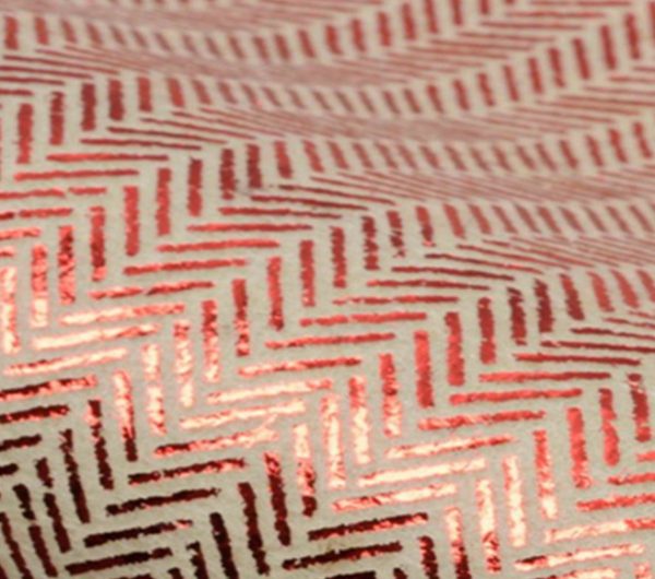 Sample of an un-woven fabric with red print repeat on top