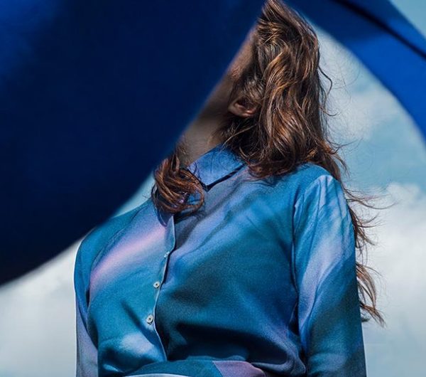 A female model is pictured in a blue dress